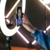 a woman recording herself with a smartphone