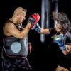 woman punching the hand of man wearing training gloves